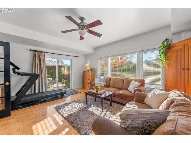 a living room with furniture a rug and a flat screen tv