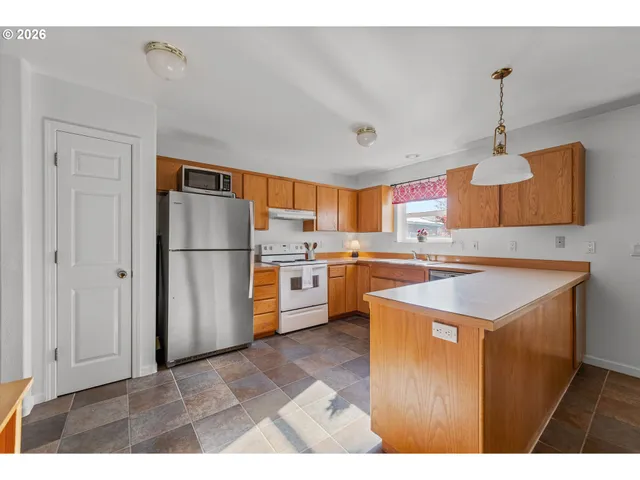 a kitchen with a refrigerator a sink and dishwasher