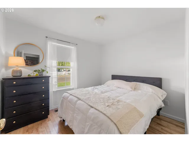 a bedroom with a bed and a lamp