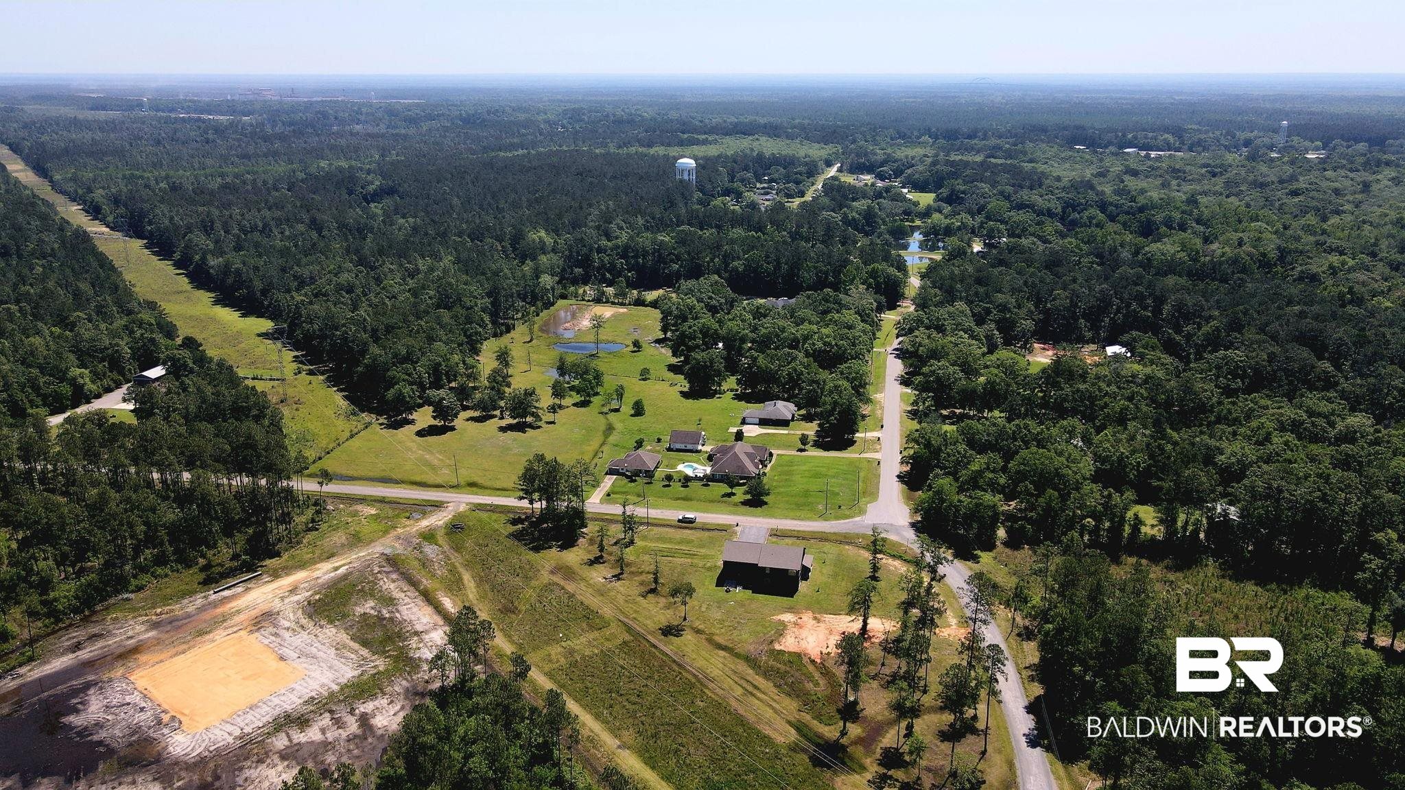 11025 Creax Road Axis, AL 36505 - Photo 37 of 45 Sprawling wooded landscape featuring multiple single-story residences, established roads, and a visible water tower