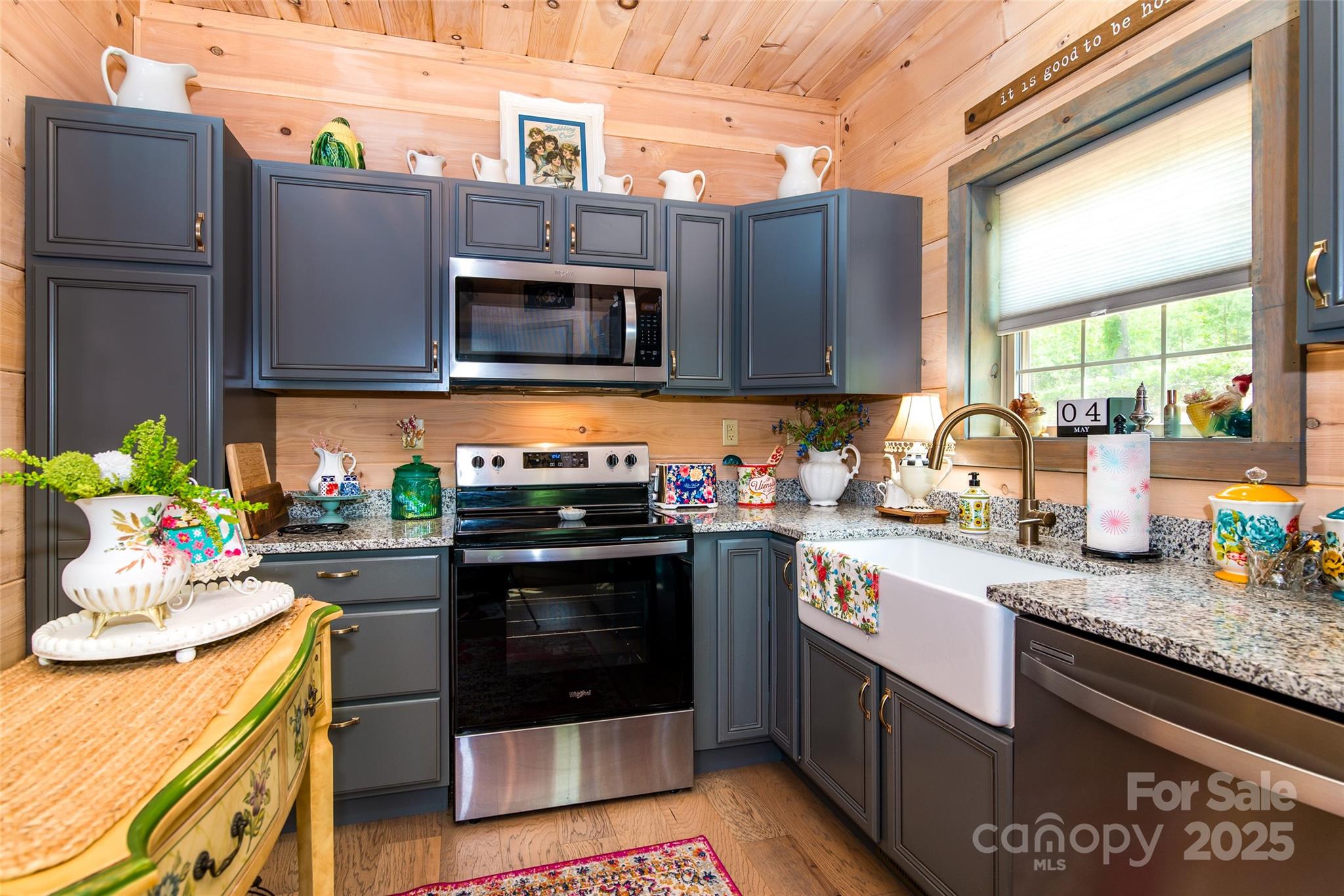 720 Cedar Creek Farm Road Tuckasegee, NC 28783 - Photo 11 of 19 a kitchen with stainless steel appliances granite countertop a stove a sink and a microwave