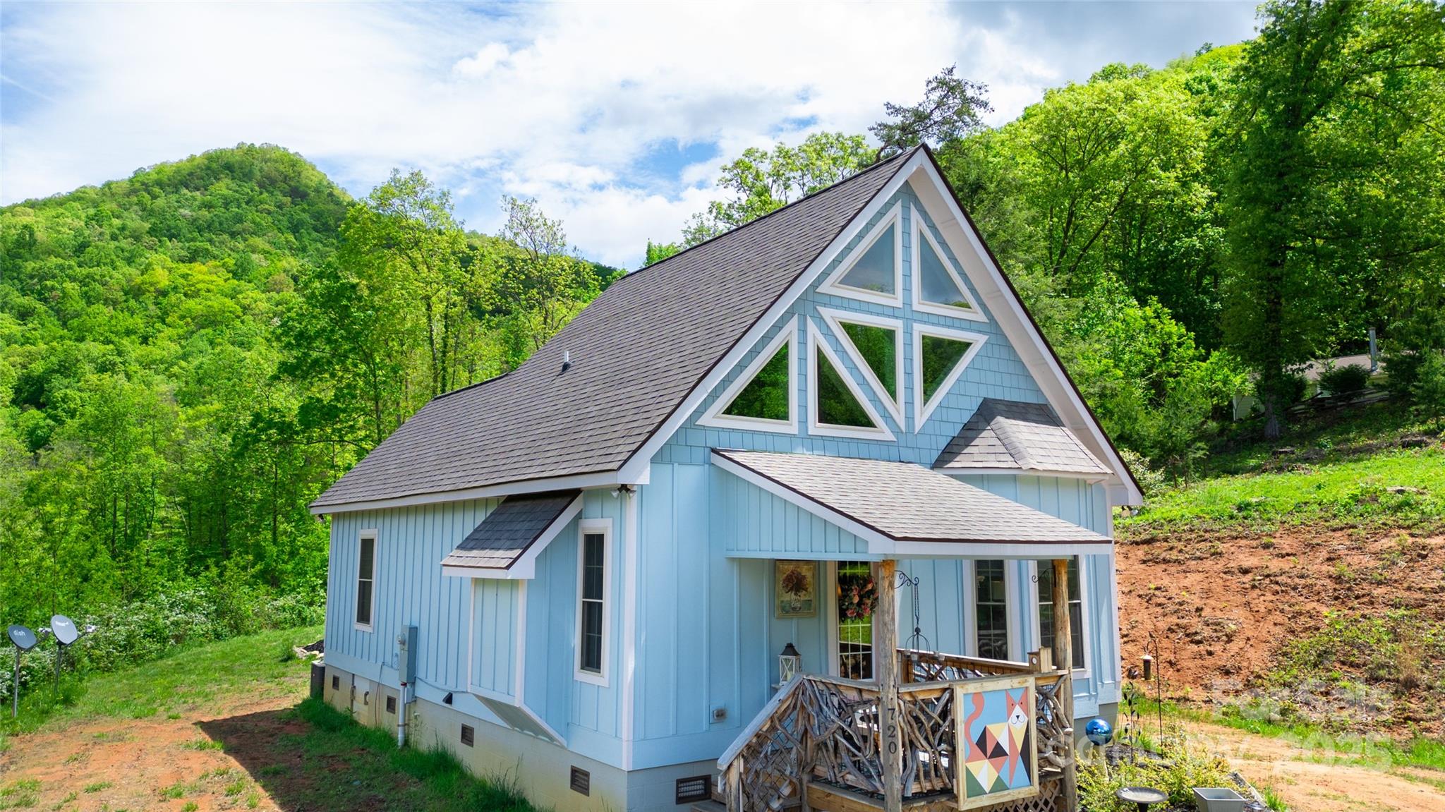 720 Cedar Creek Farm Road Tuckasegee, NC 28783 - Photo 4 of 19 a front view of house with yard and green space
