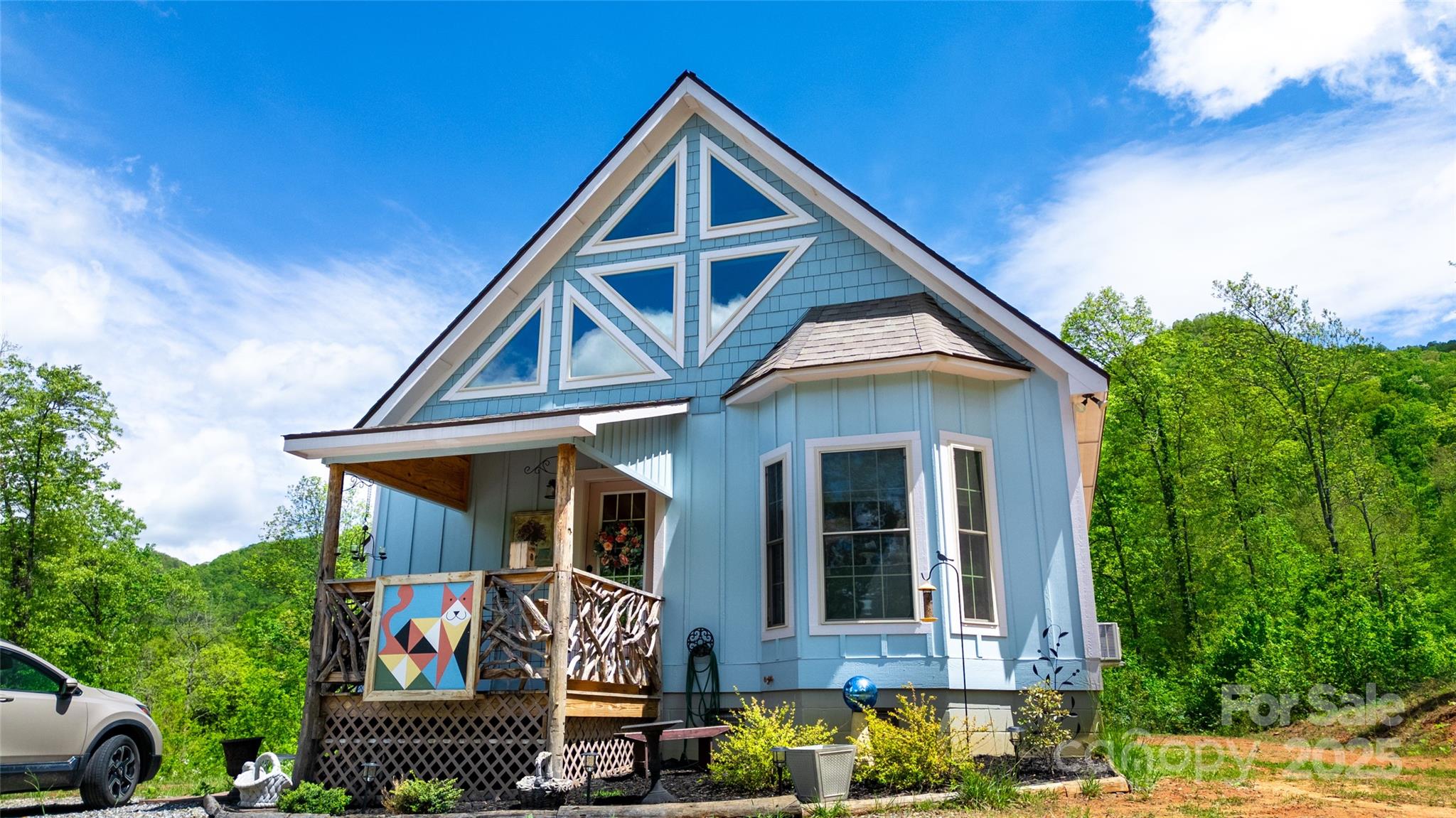 720 Cedar Creek Farm Road Tuckasegee, NC 28783 - Photo 5 of 19 a front view of a house with garden