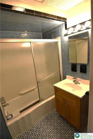 a bathroom with a sink a toilet and a shower
