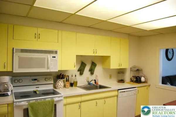 a kitchen with a sink appliances and cabinets