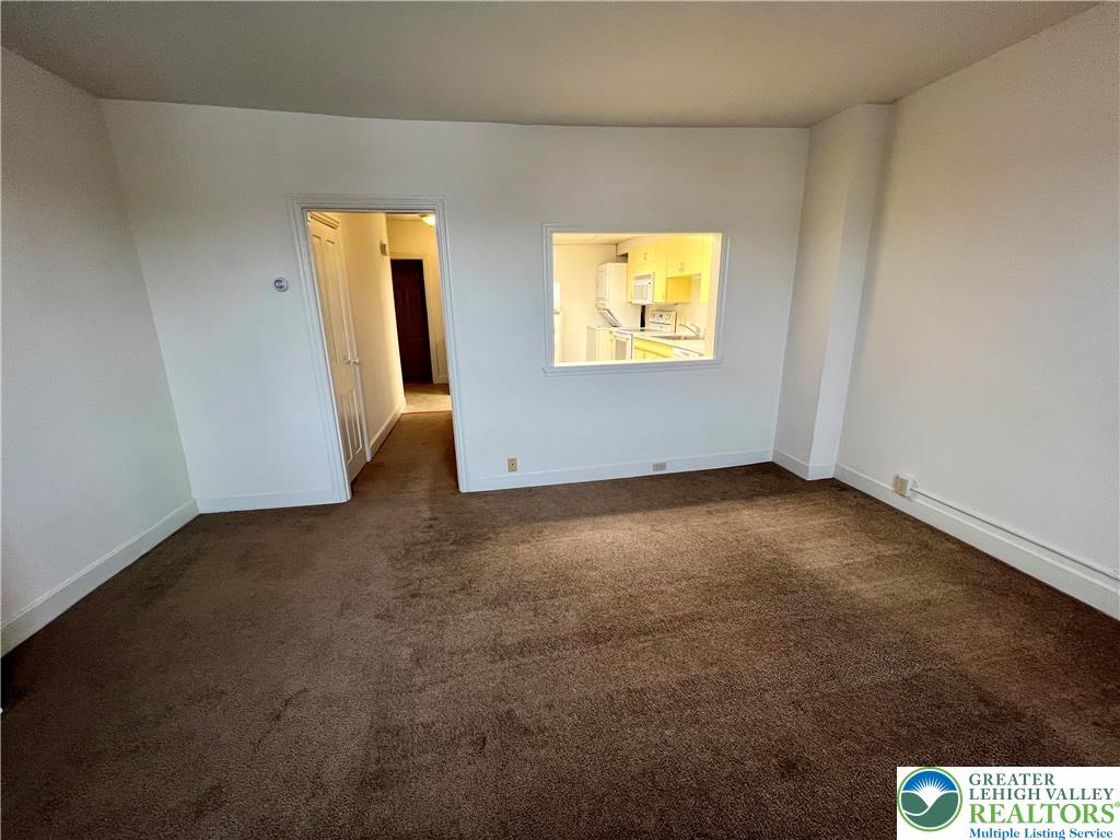 606 West Broad Street, Unit F Bethlehem, PA 18018 - Photo 6 of 12 a view of an empty room with wooden floor and a window