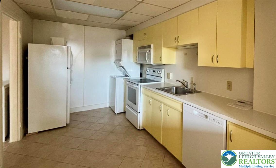 606 West Broad Street, Unit F Bethlehem, PA 18018 - Photo 7 of 12 a kitchen with stainless steel appliances granite countertop a refrigerator a stove and a sink