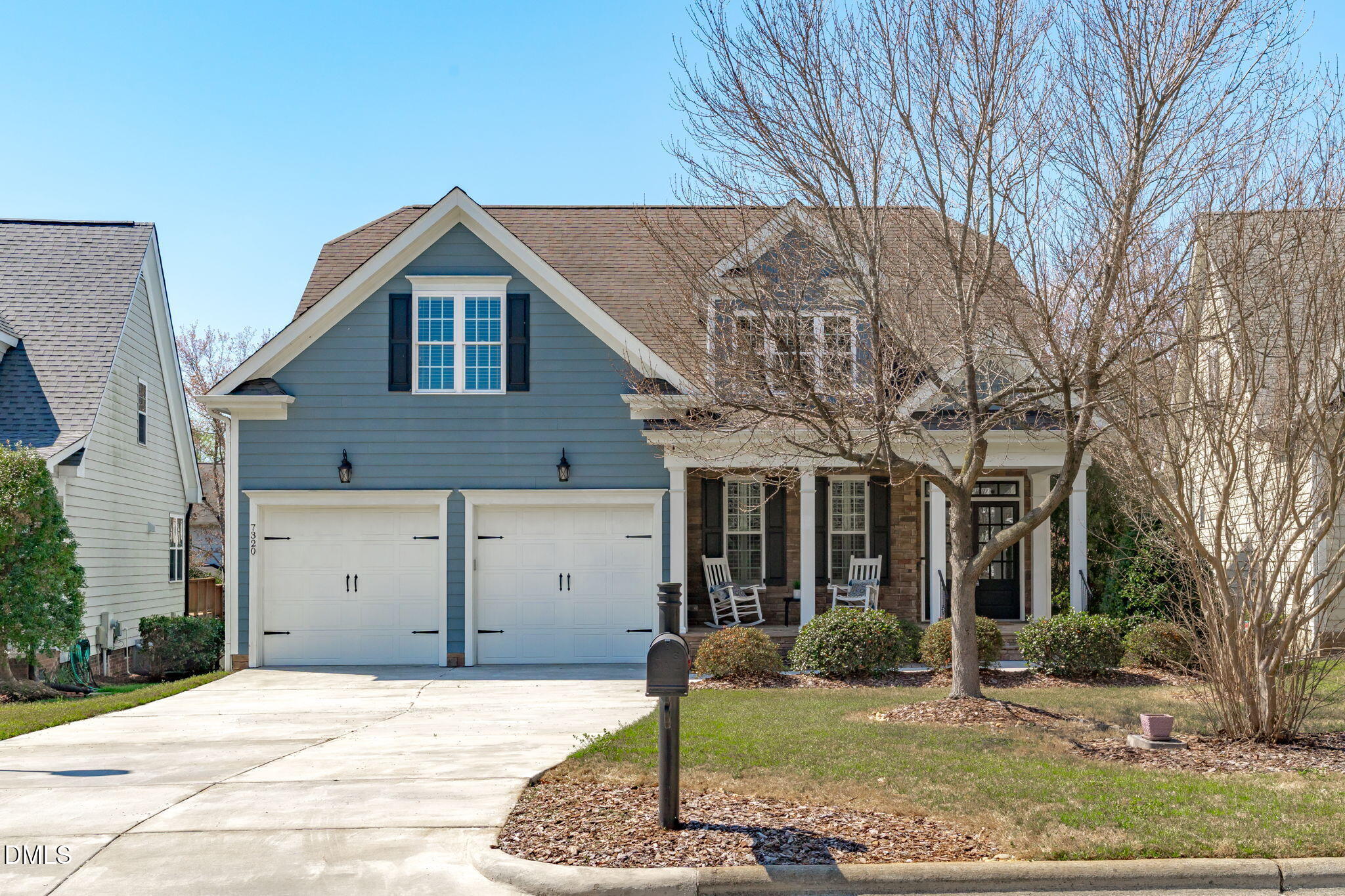 7320 Bedford Ridge Drive Apex, NC 27539 - Photo 1 of 64 a front view of a house with garden
