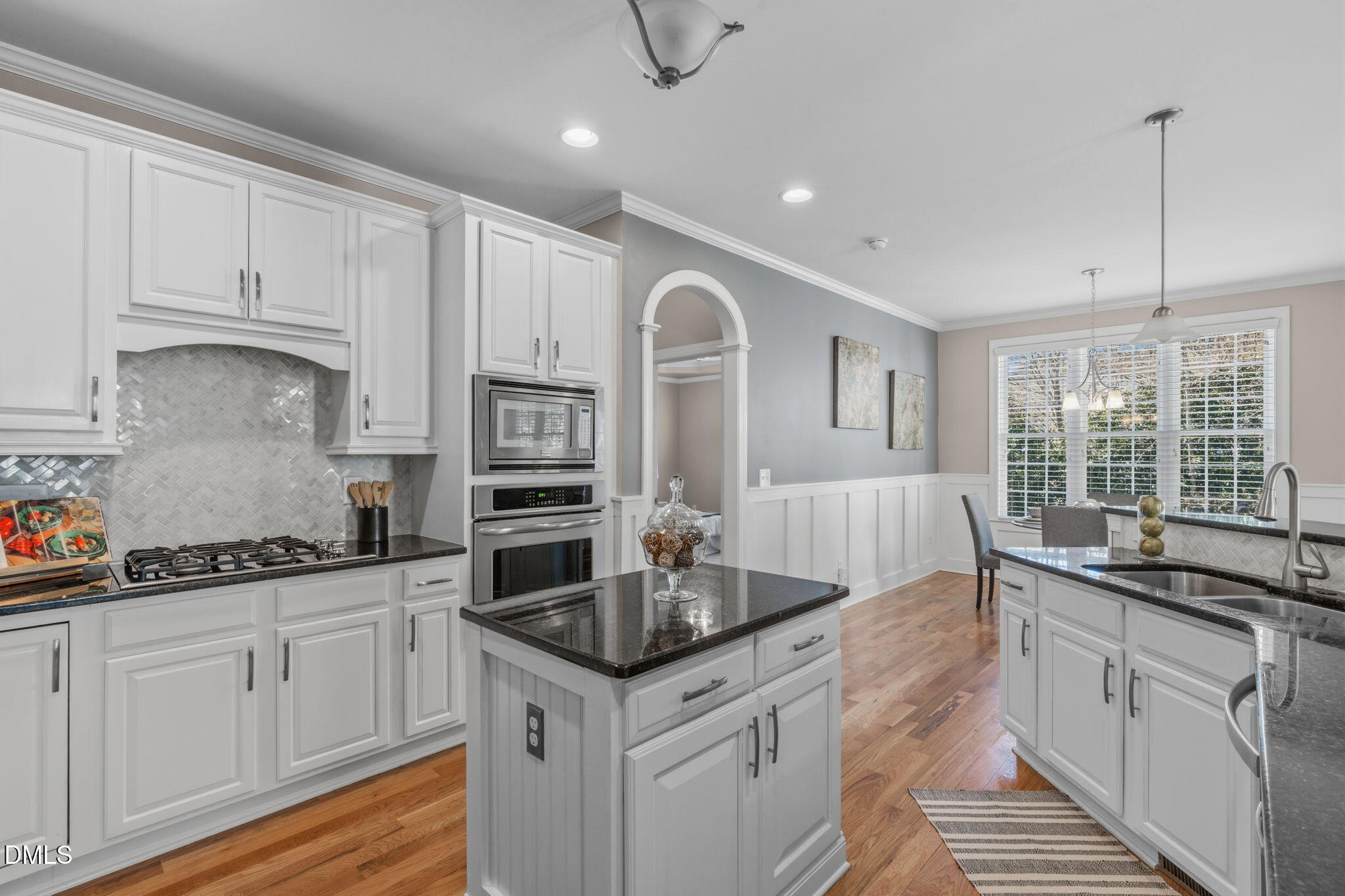 7320 Bedford Ridge Drive Apex, NC 27539 - Photo 14 of 64 a kitchen with granite countertop a sink a counter space appliances and cabinets