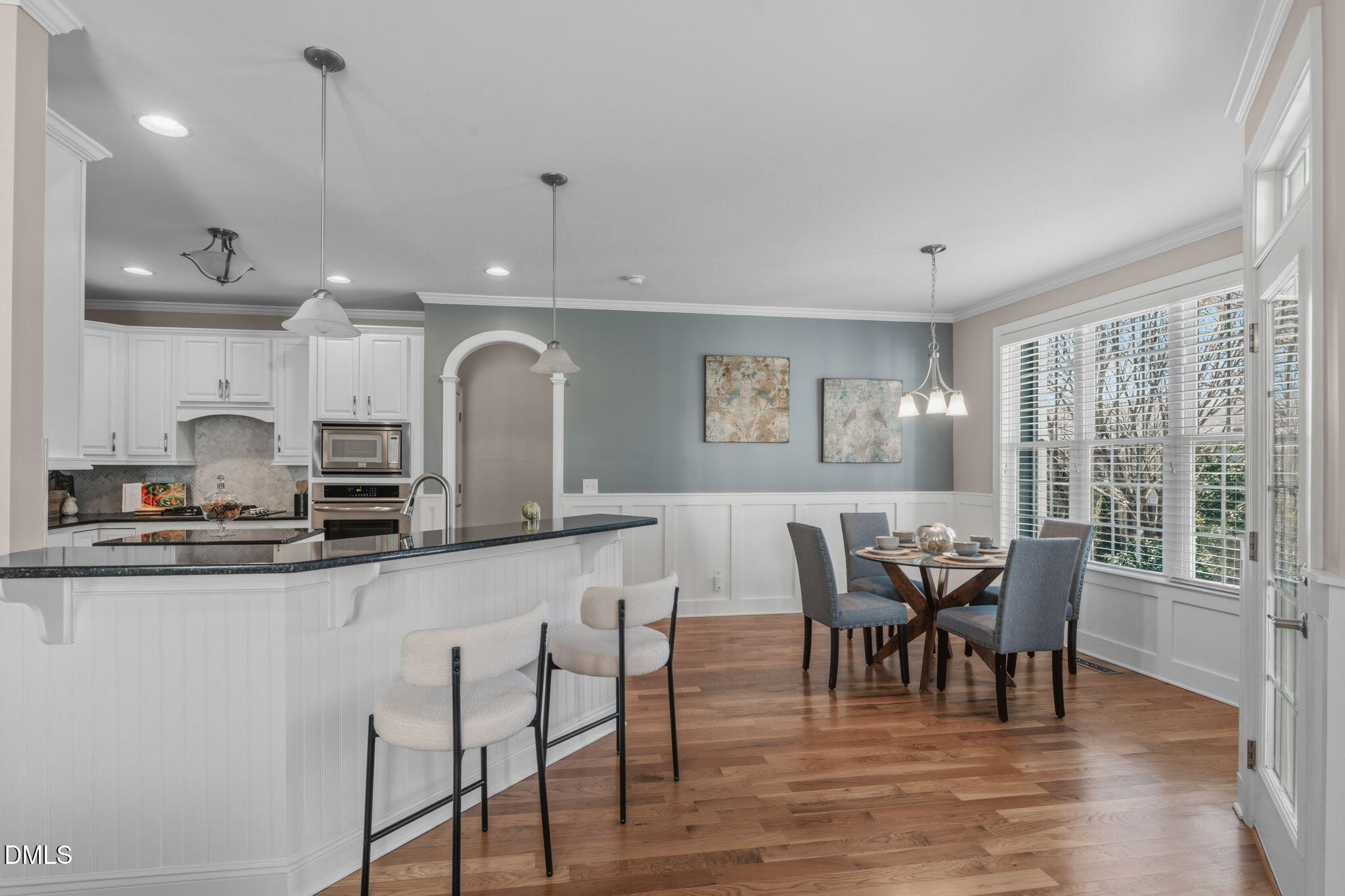 7320 Bedford Ridge Drive Apex, NC 27539 - Photo 15 of 64 a view of a dining room with furniture window and wooden floor