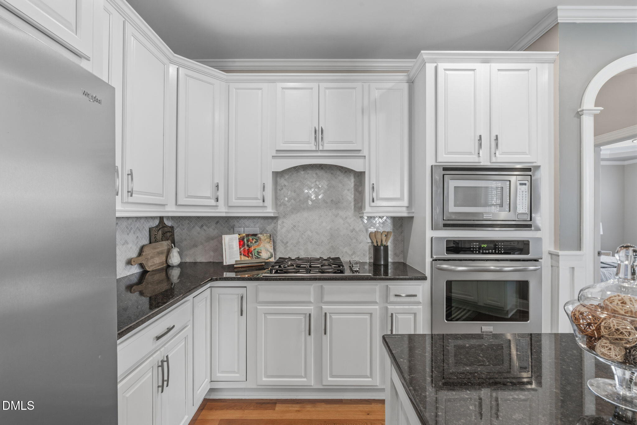7320 Bedford Ridge Drive Apex, NC 27539 - Photo 17 of 64 a kitchen with white cabinets and a stove