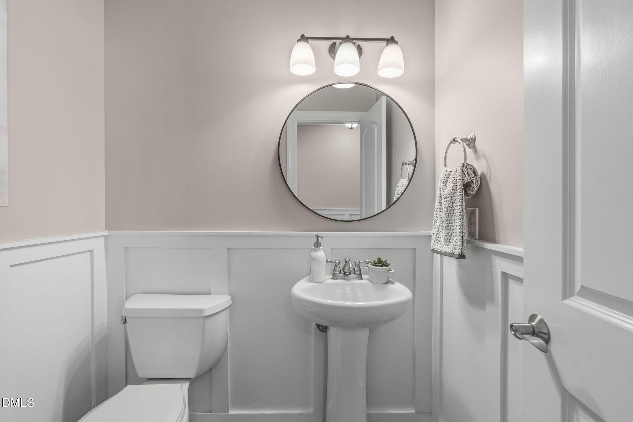 7320 Bedford Ridge Drive Apex, NC 27539 - Photo 24 of 64 a bathroom with a toilet sink and mirror