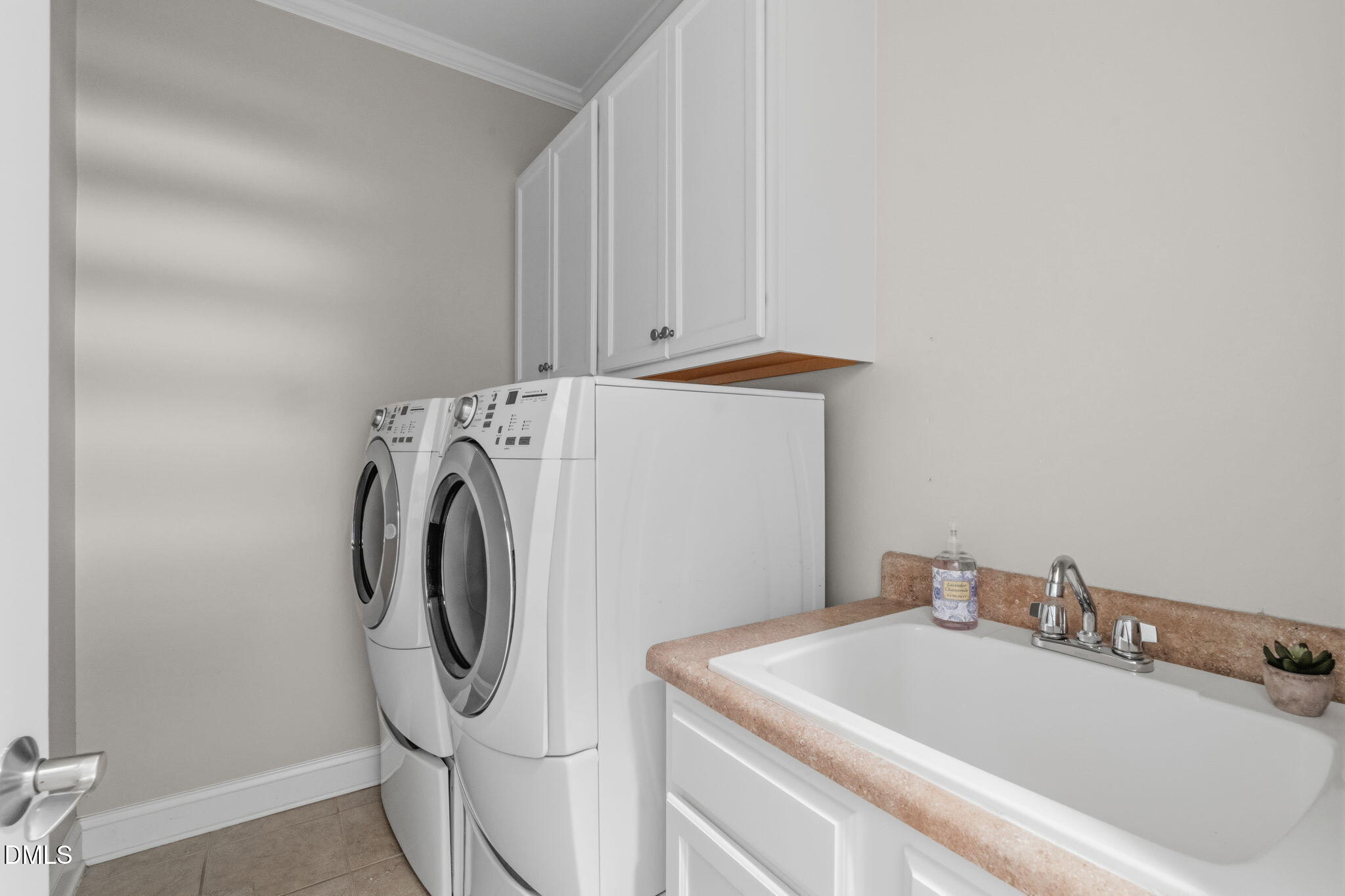 7320 Bedford Ridge Drive Apex, NC 27539 - Photo 25 of 64 a bathroom with a sink and washing machine