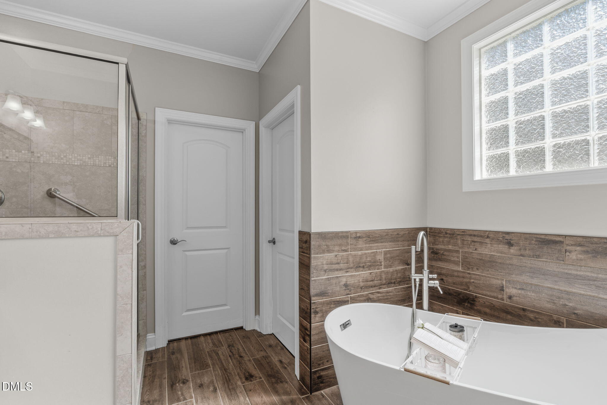 7320 Bedford Ridge Drive Apex, NC 27539 - Photo 33 of 64 a bathroom with a tub a sink and a window