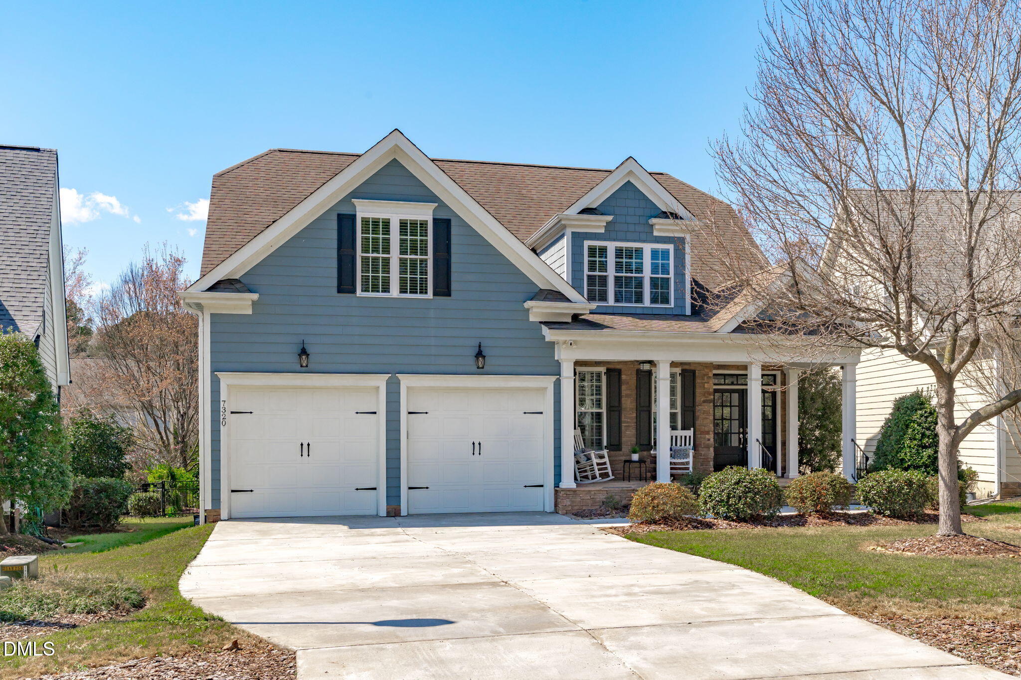 7320 Bedford Ridge Drive Apex, NC 27539 - Photo 3 of 64 a front view of a house with garden