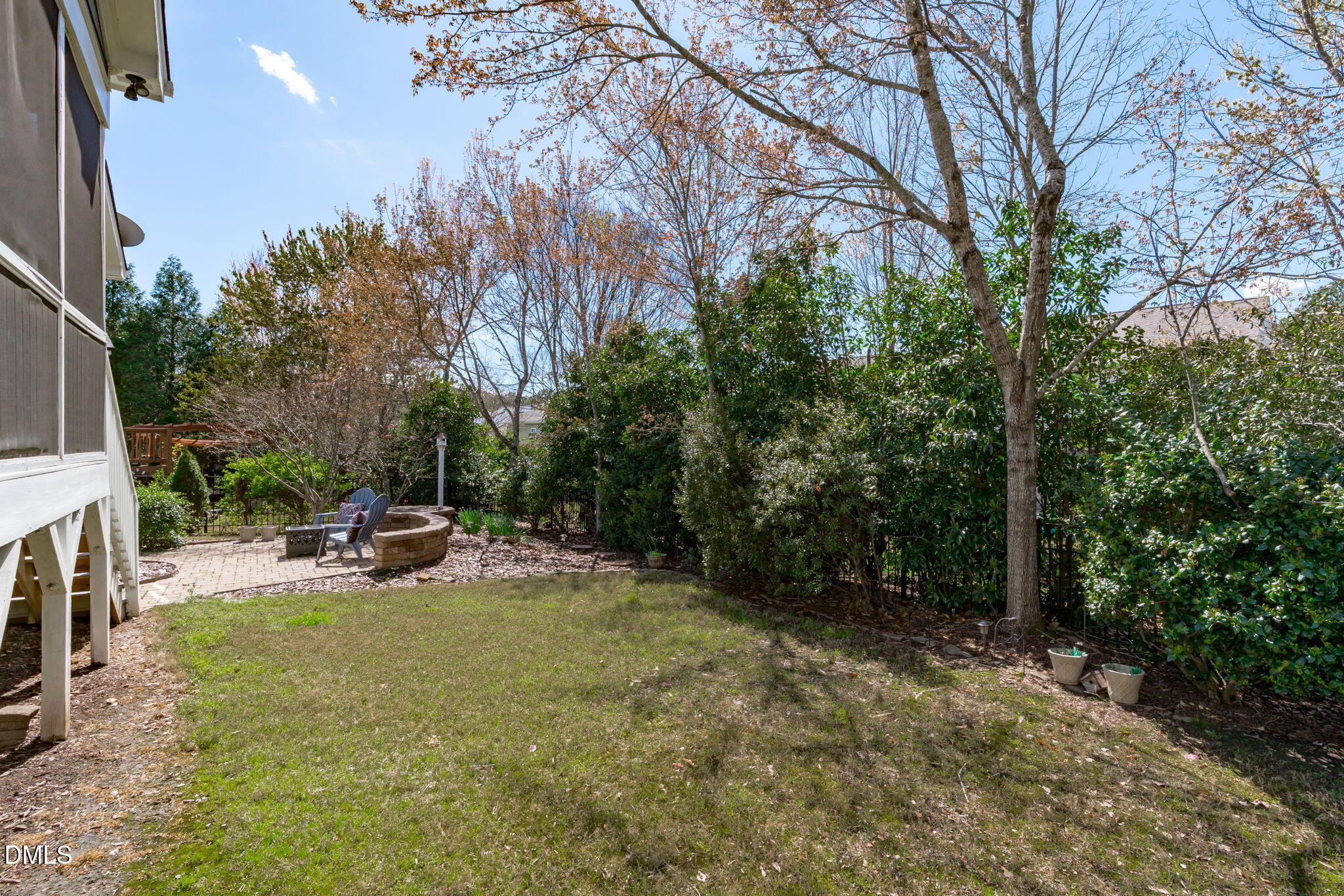 7320 Bedford Ridge Drive Apex, NC 27539 - Photo 51 of 64 a view of a backyard with a patio and fire pit