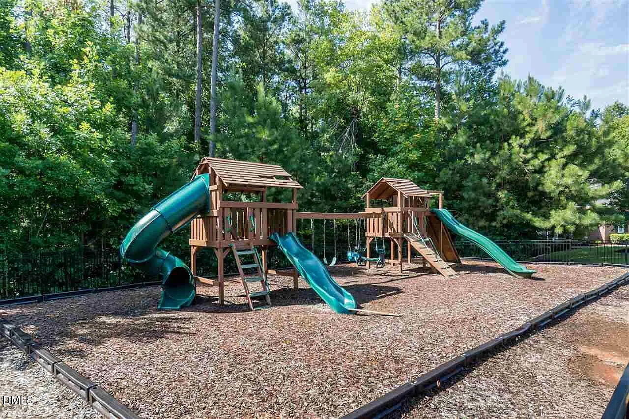 7320 Bedford Ridge Drive Apex, NC 27539 - Photo 62 of 64 a wooden deck with a tree in the background