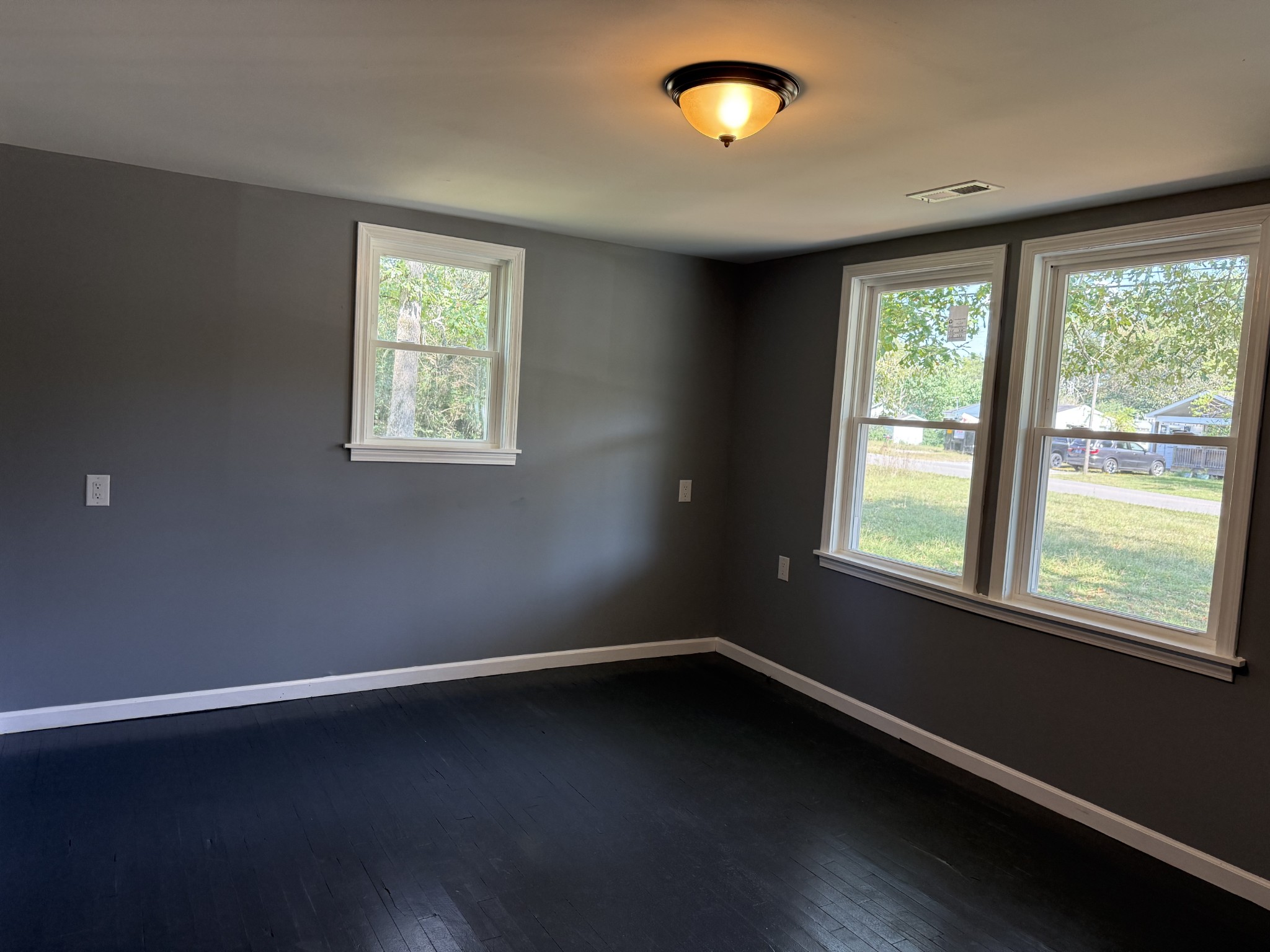 235 Richland Richardson Road Murfreesboro, TN 37130 - Photo 8 of 10 an empty room with wooden floor and windows