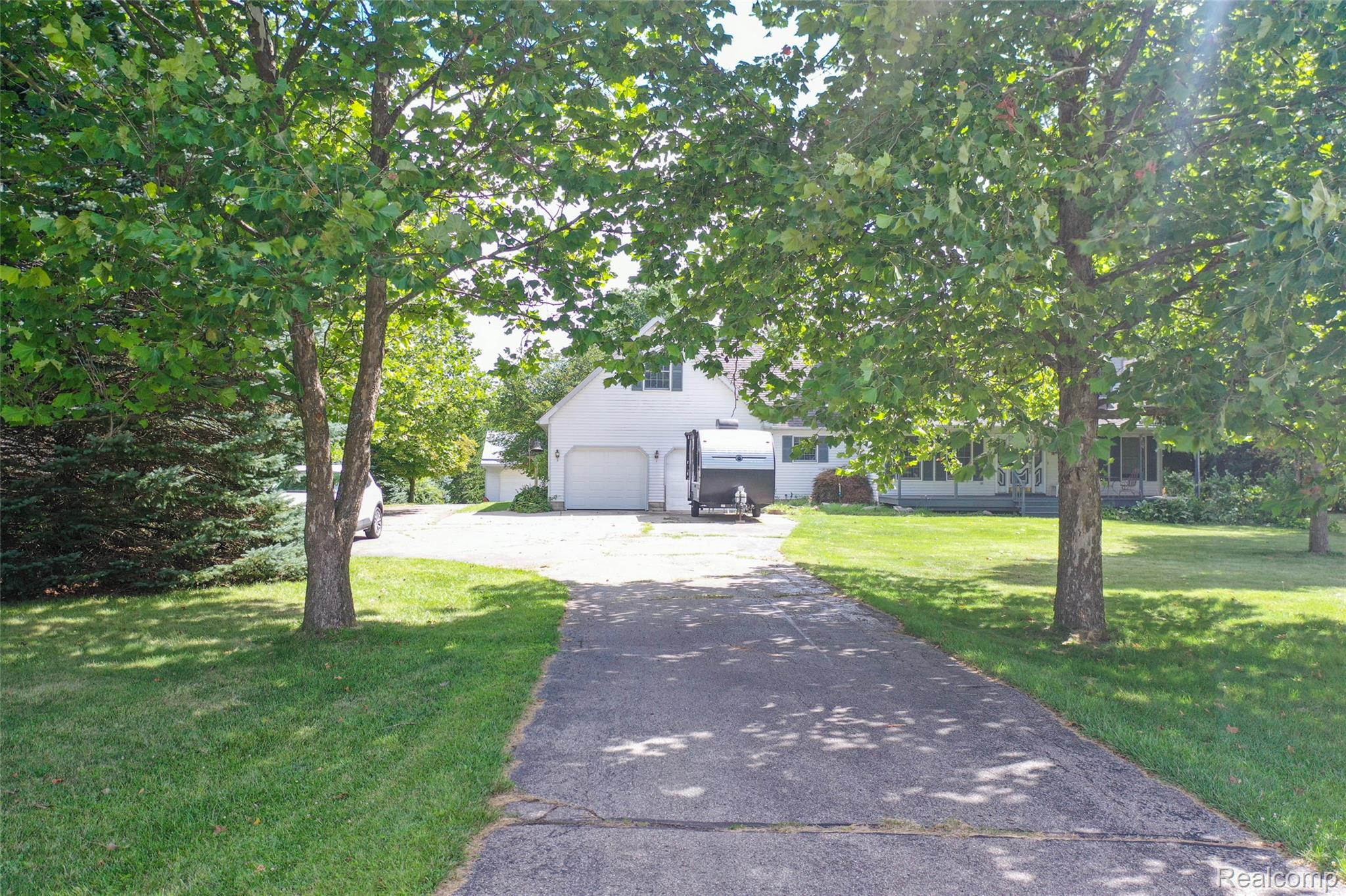 1591 Baldwin Road Lapeer, MI 48446 - Photo 32 of 46 Obstructed view of property featuring asphalt driveway and a front yard