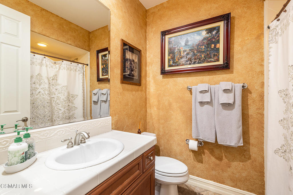 5019 Corral Street Simi Valley, CA 93063 - Photo 15 of 50 a bathroom with a sink mirror vanity and toilet