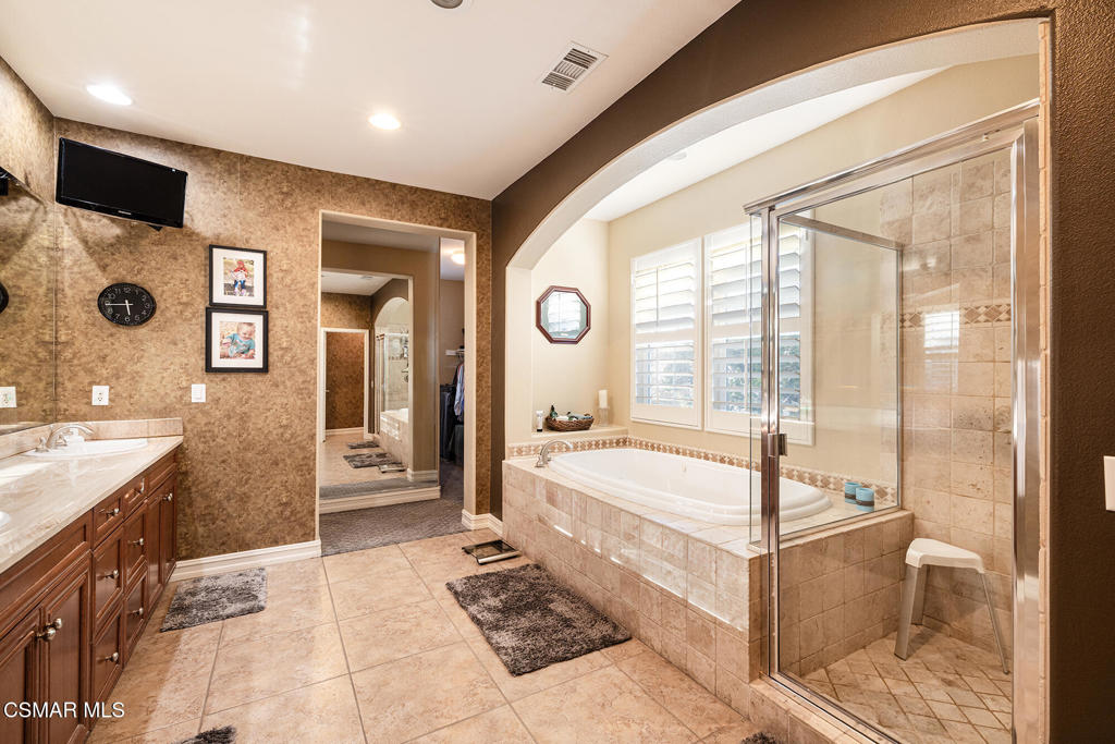 5019 Corral Street Simi Valley, CA 93063 - Photo 20 of 50 a large spacious bathroom with a large tub and sink