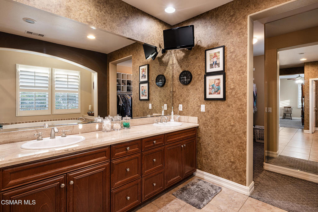 5019 Corral Street Simi Valley, CA 93063 - Photo 21 of 50 a spacious bathroom with double vanity and a mirror