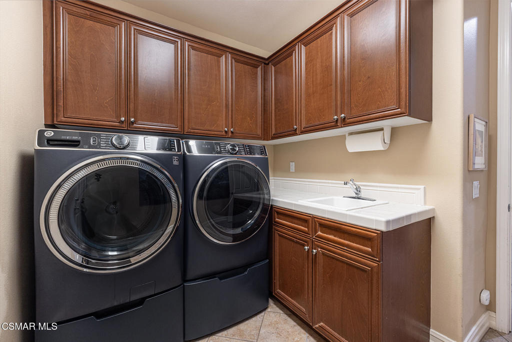 5019 Corral Street Simi Valley, CA 93063 - Photo 27 of 50 a utility room with sink dryer and washer