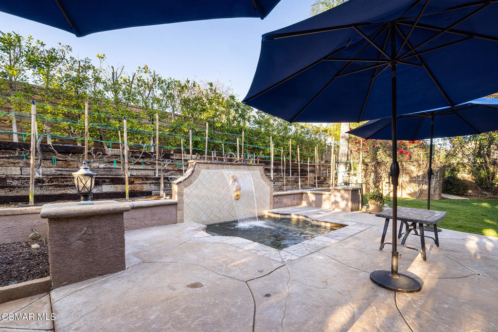 5019 Corral Street Simi Valley, CA 93063 - Photo 29 of 50 a view of a patio with a table and chairs under an umbrella