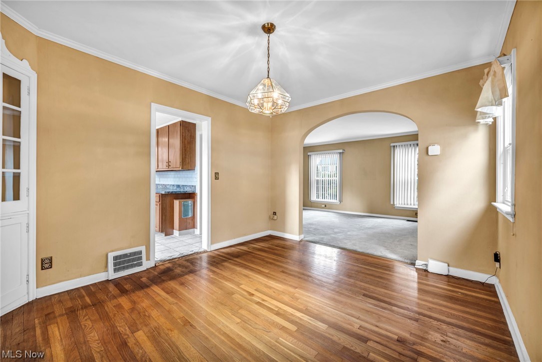 3946 Lansdale Road Cleveland, OH 44118 - Photo 17 of 42 Dining Room with crown molding, a chandelier, and wood-type flooring
