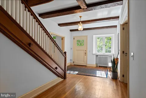 a view of entryway and hall with wooden floor