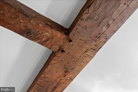 an empty room with windows and fireplace