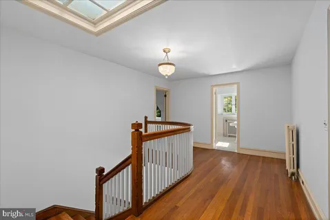 an empty room with large windows and fireplace