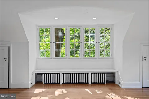 wooden floor fireplace and natural light in room