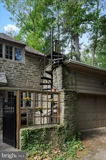a view of a big building with a big yard and large trees