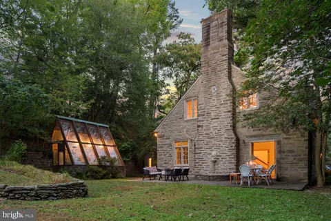 a view of a chairs and table in backyard of the house