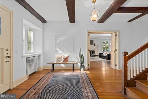 a view of a livingroom with wooden floor and a potted plant