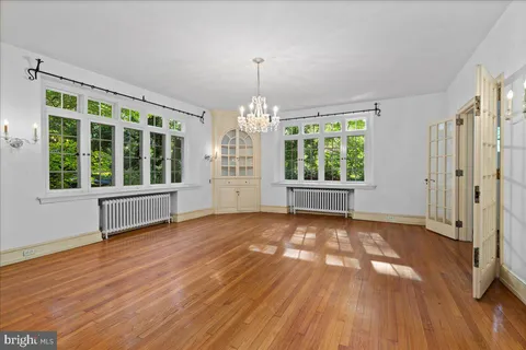 a kitchen with white cabinets sink and dishwasher with wooden floor