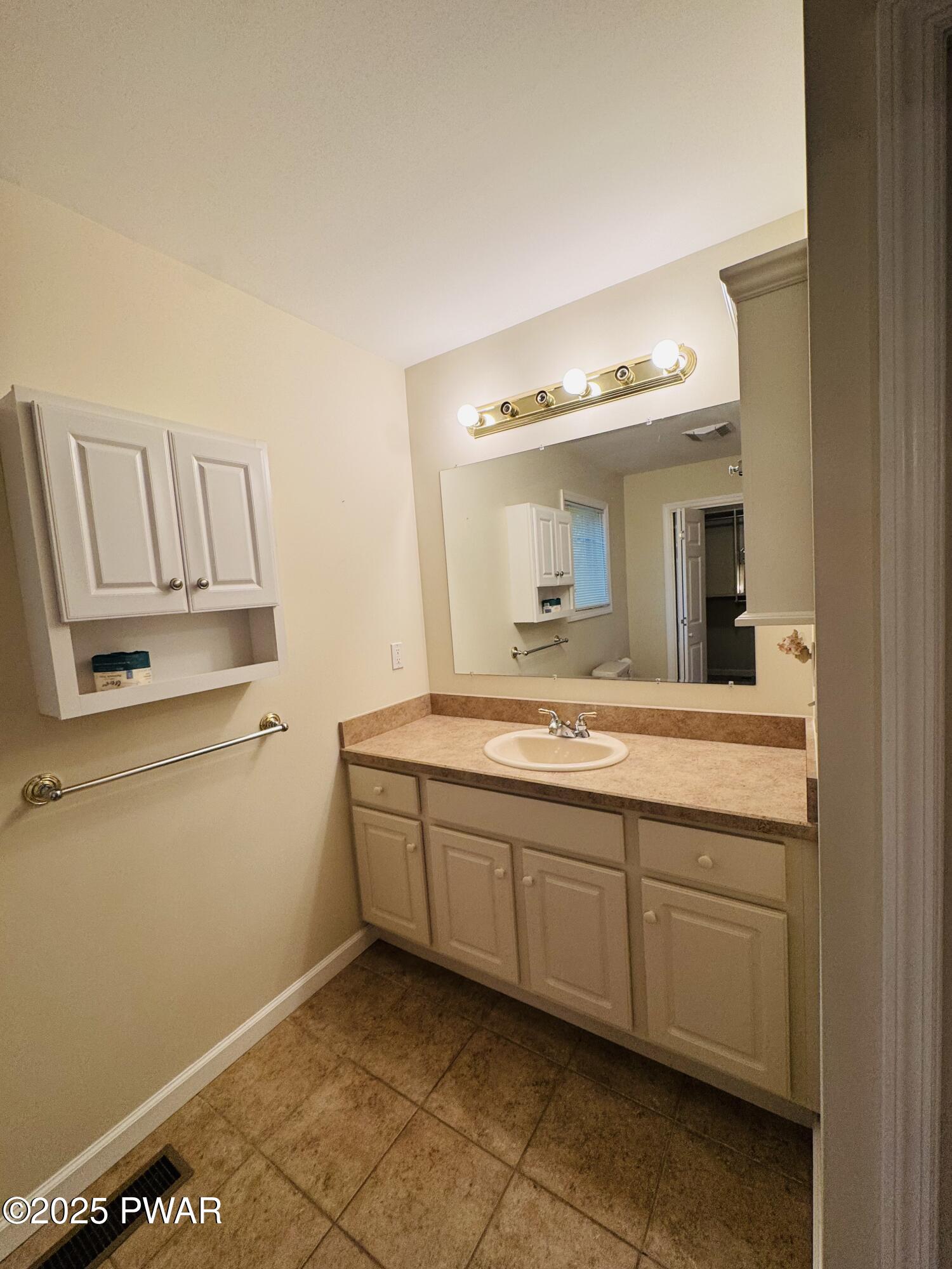 137 Rodeo Drive Hawley, PA 18428 - Photo 15 of 68 a bathroom with a sink a vanity and mirror