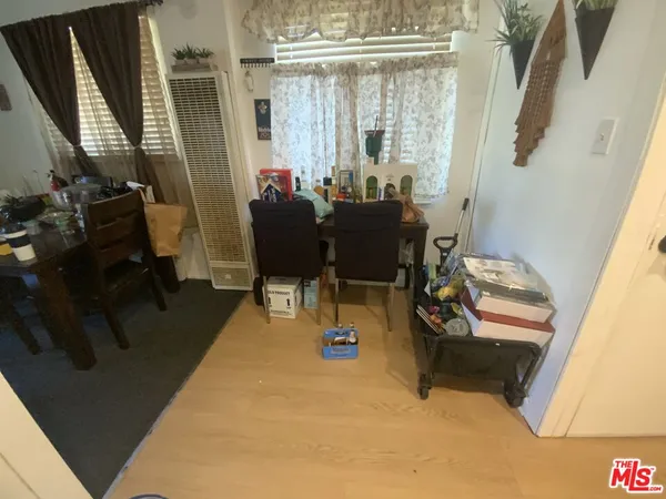 a dining room with furniture and a floor to ceiling window