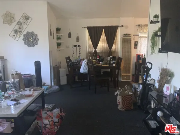 a dining room with furniture and a floor to ceiling window