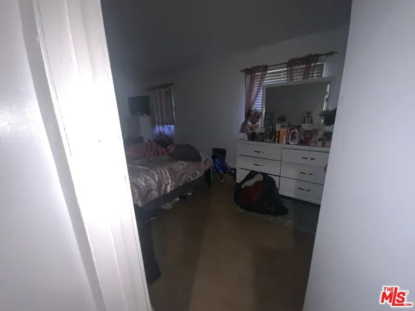a bedroom with a bed and cabinets