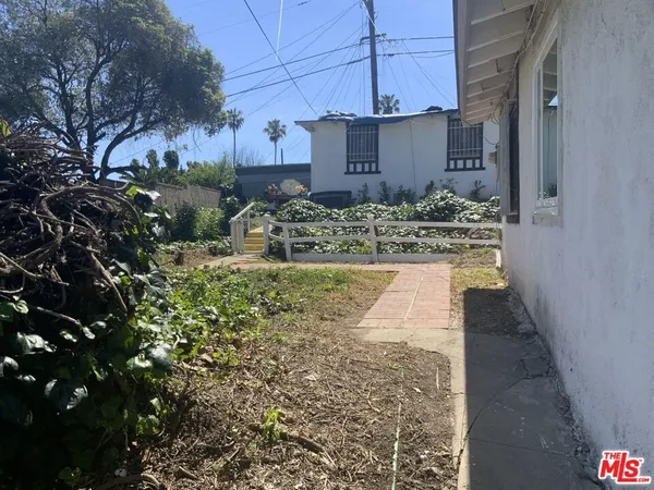 a view of a wooden fence and a yard