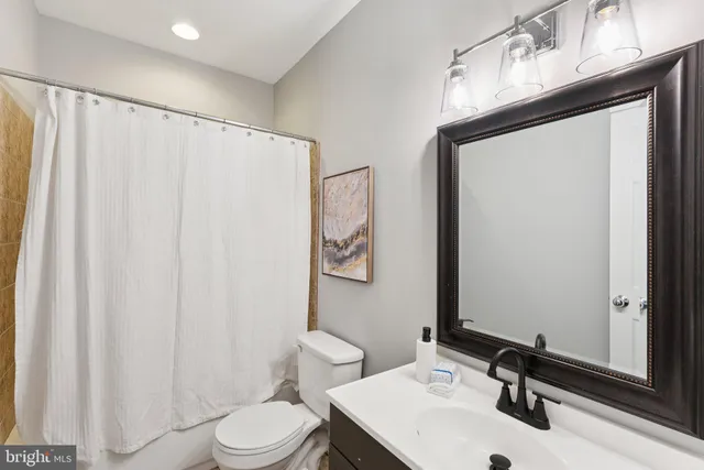 a kitchen with stainless steel appliances granite countertop a stove top oven a sink dishwasher and cabinets with wooden floor