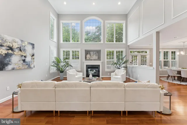 a living room with furniture a large window and a fireplace