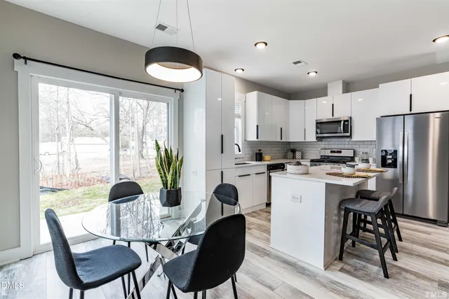 a bathroom with a sink mirror and a shower