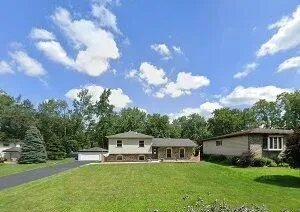 a view of a house with a backyard