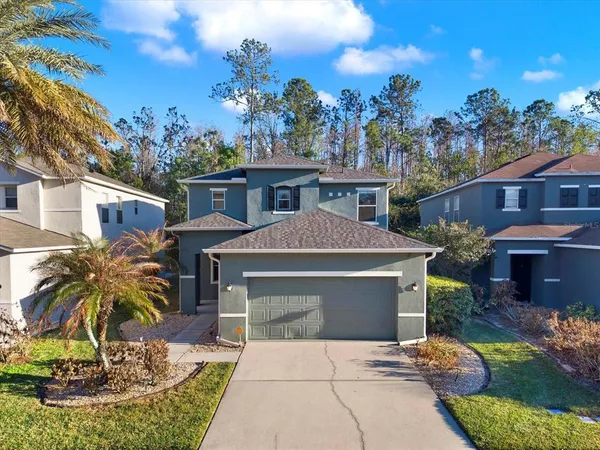 a front view of a house with a yard garage and outdoor seating