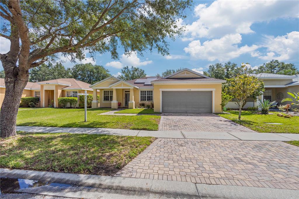 a view of house with a garden and pathway