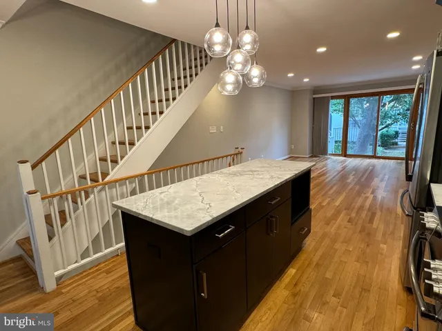 a kitchen with sink and wooden floor