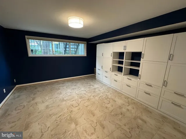a view of empty room with cabinet